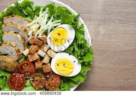 Caesar Salad With Fried Chicken, Fresh Tomatoes, Croutons, Lettuce, Parmesan Cheese And Eggs. Health