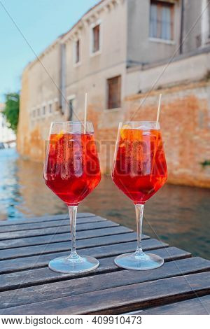 Two Glasses Of Spritz Veneziano Cocktail Served Near The Venetian Canal.