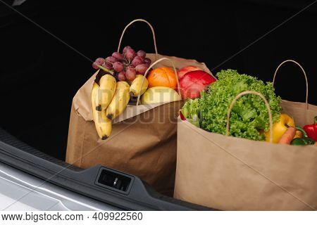 Groceries From A Supermarket In A Car Trunk. Food Delivery During Quarantine. Cruft Paper Eco Bags F
