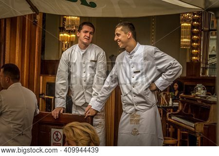 Prague, Czechia - July 2, 2014: Two Waiters, In Traditional Reto Uniform, Waiting For Clients In A C