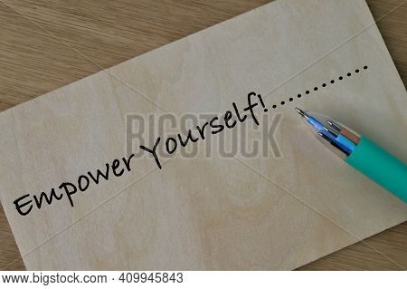 Pen And Wooden Board Written With Text Empower Yourself
