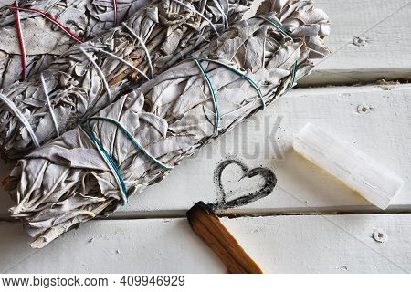 A Close Up Image Of Healing White Sage Smudge Bundles White Healing Crystals On A White Table Top.