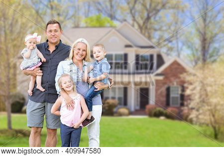 Happy Young Caucasian Family Outside  In Front of Their New Home.