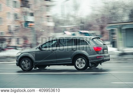 Moscow, Russia - January 29, 2021: Fast Moving Suv Rides On A Winter City Road. A Car On Wet Slipper