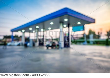 Abstract Blur Photo Of Car Refueling On Gas Station At Sunset. Pump Gasoline Gauge Oil In The Evenin