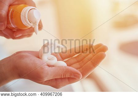 Woman Hands Putting Sunscreen From A Suncream Bottle