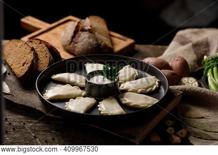 Appetizing Traditional Russian Dumplings, Hand-made With Potatoes. Still Life On A Wooden Board. Clo