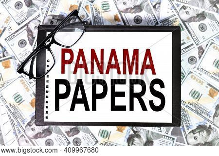 Panama Papers. Text On White Paper On The Background Of Banknotes And Dollar Bills