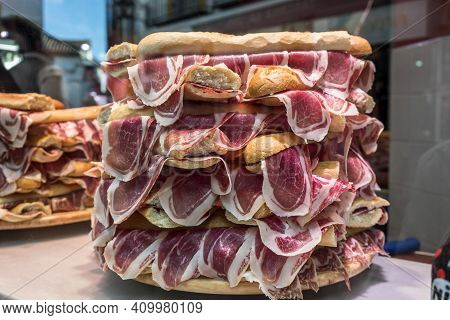 Several Jamon Serrano Sandwiches Piled Up In A Shop Window, Conceptual Image