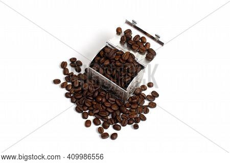 Roasted Coffee Beans In A Small Metal Chest Around It. Isolate On A White Background. Copspace