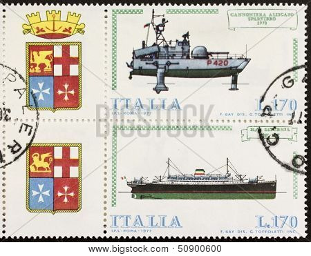ITALY Ã?ÃÂ¢?? CIRCA 1977: a block of two stamps printed in Italy shows illustrations of  Italian old hydrofoil gunboat and cruise ship and coat of arms of Italian Royal Navy. Italy, circa 1977