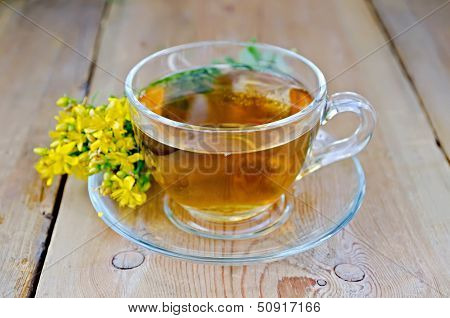 Herbal Tea From Tutsan In A Glass Cup On A Board