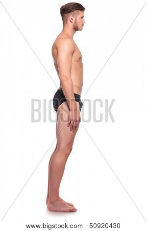 side view of a young man wearing nothing but his underware. isolated on white