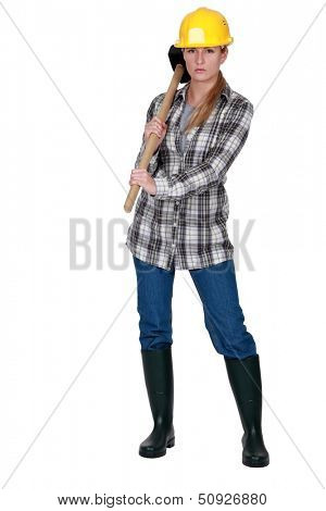 Moody labourer carrying a mallet