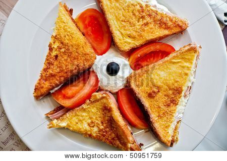 Toasted pressed sandwich with ham and cheese.