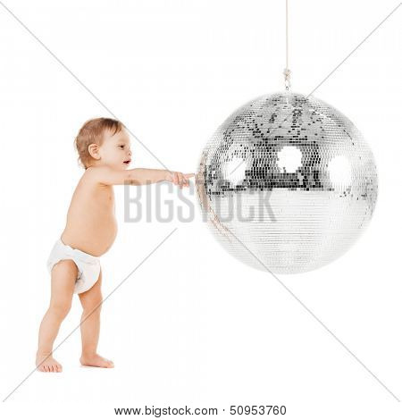 childhood and toys concept - cute little toddler playing with disco ball