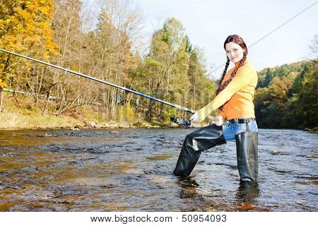 woman fishing in Otava river, Czech Republic