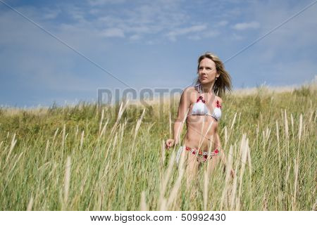 Young  beautiful woman on the dune