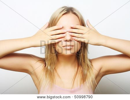 teen girl with her hands covering her eyes. close up.