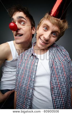 Two funny guys looking at camera and smiling crazily, fools day series