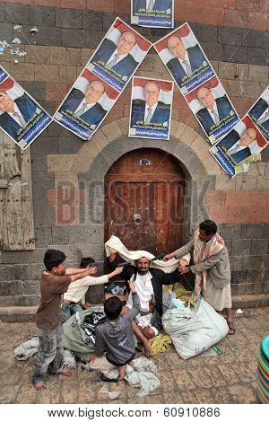 SANAA, YEMEN - MARCH 22, 2012: Children playing with toy guns on the street of Sanaa