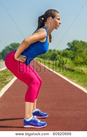 Young female athlete warming before a competition