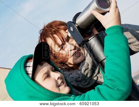 Young Boy With Her Grandmother Looking Through A Telescope