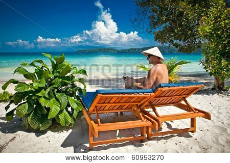 Man on a tropical beach at Koh Rong Samloem island  in Cambodia.