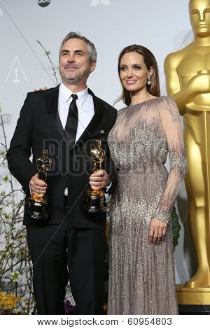 LOS ANGELES - MAR 2:: Alfonso Cuaron, Angelina Jolie  in the press room at the 86th Annual Academy Awards on March 2, 2014 in Los Angeles, California