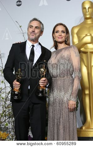 LOS ANGELES - MAR 2:: Alfonso Cuaron, Angelina Jolie  in the press room at the 86th Annual Academy Awards on March 2, 2014 in Los Angeles, California