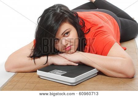 Overweight woman with weighing machine