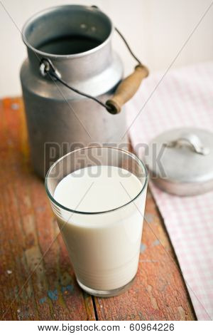 the milk in glass on old wooden table