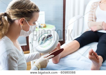 Woman receiving podiatry treatment in a Day Spa