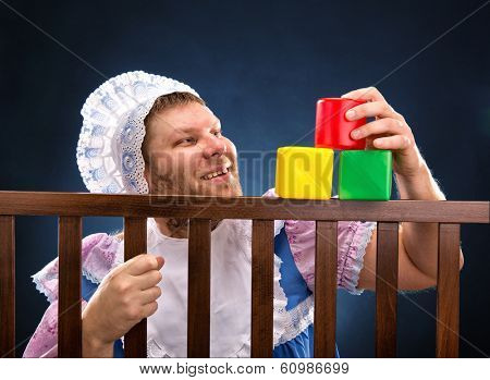Man in playpen playing