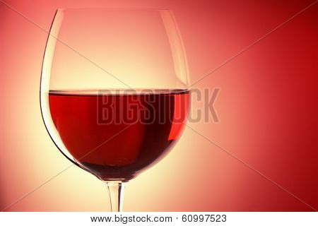 glass of red wine, backlited, with space for text