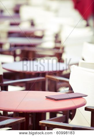 summer cafe table, shallow DOF, focus on menu