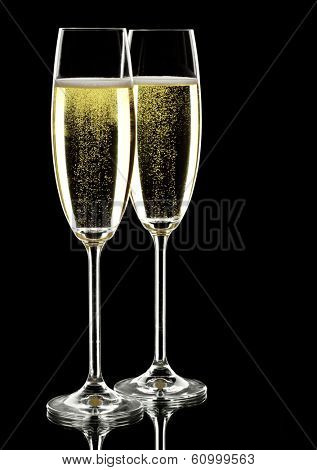 two glasses of sparkling wine, over black, studio shot