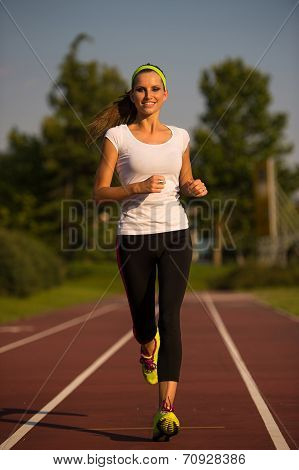 Preety Young Woman Running On A Track