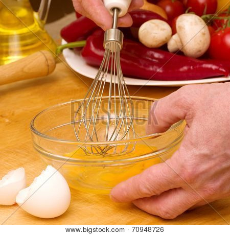 Chef baker beating an egg