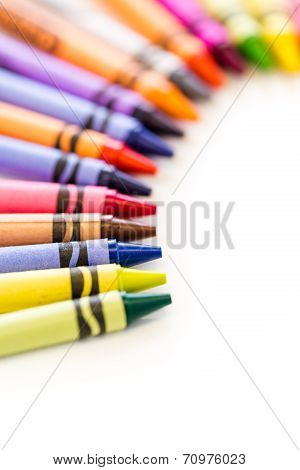 New Multicolored crayons on a white background.