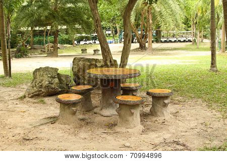 cement garden chair in beautiful garden
