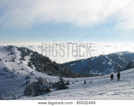 Hiker in winter mountains snowshoeing.