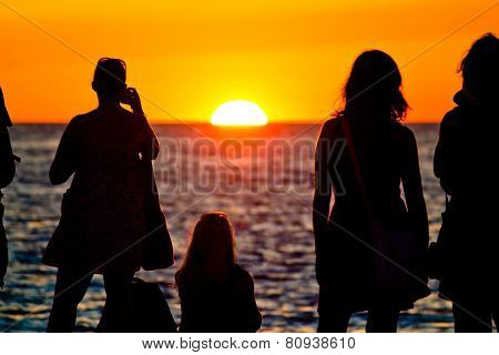Women Silhouette Watching Sunset On Sea Coast