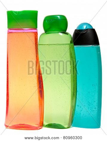 colored plastic bottles with liquid soap and shower gel.