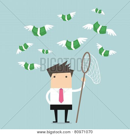 Concept businessman trying to catch money fly