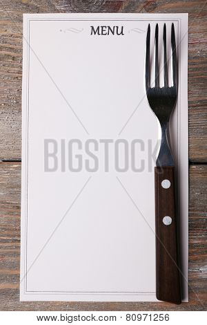 Menu sheet of paper on rustic wooden surface background