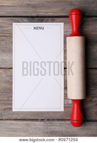 Menu sheet of paper on rustic wooden surface background