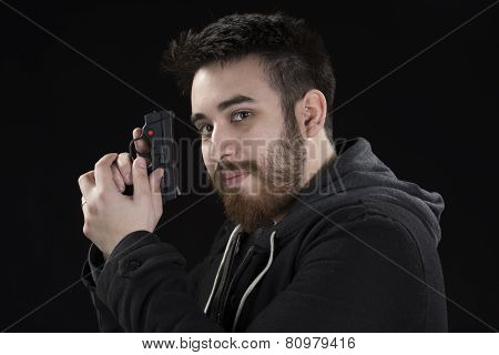 Goatee Young Man in Jacket Holding Small Gun