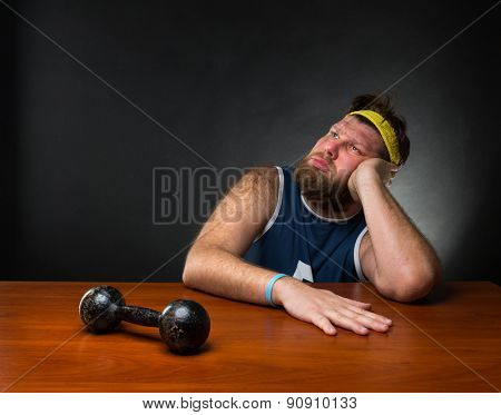 Dreaming man and a dumbbell 