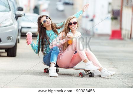 Hipster girlfriends taking a selfie in urban city context - Concept of friendship and fun with new t